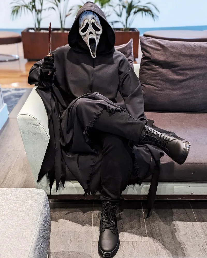 1. Matte Black Hooded Tunic with Tapered Trousers and Combat Boots