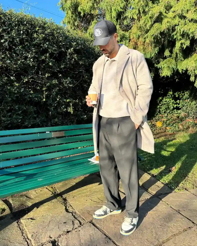 Beige Overcoat with Cream Knit Polo and Black Trousers