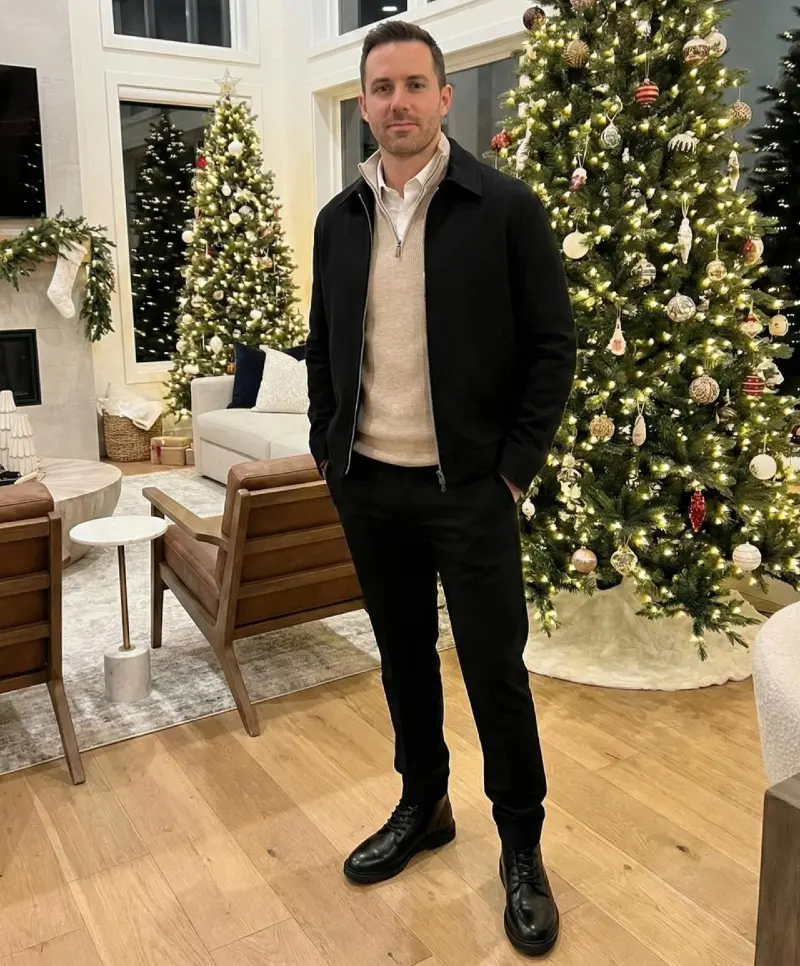 Black Zip Jacket over Beige Half-Zip Knit and Dark Trousers