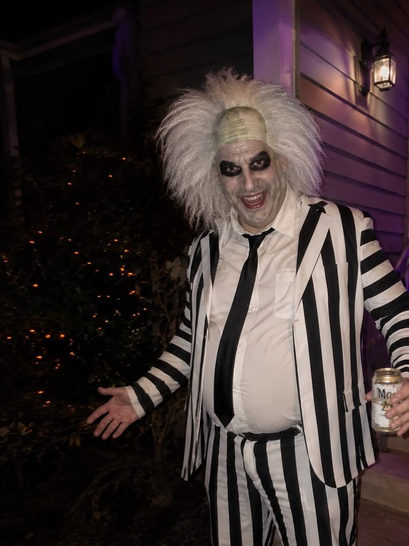 Black-and-White Striped Suit with Loose Tie and Wild White Hair