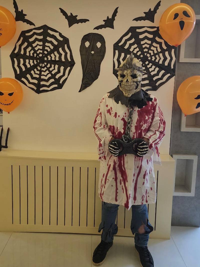 Blood-Splattered White Lab Coat with Skeleton Mask and Shackles