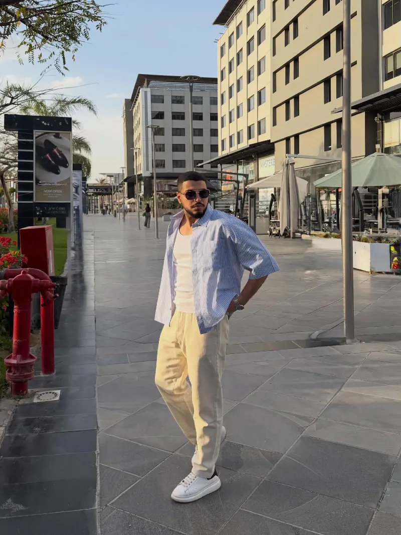 Blue Striped Short-Sleeve Shirt with White Tank and Cream Trousers