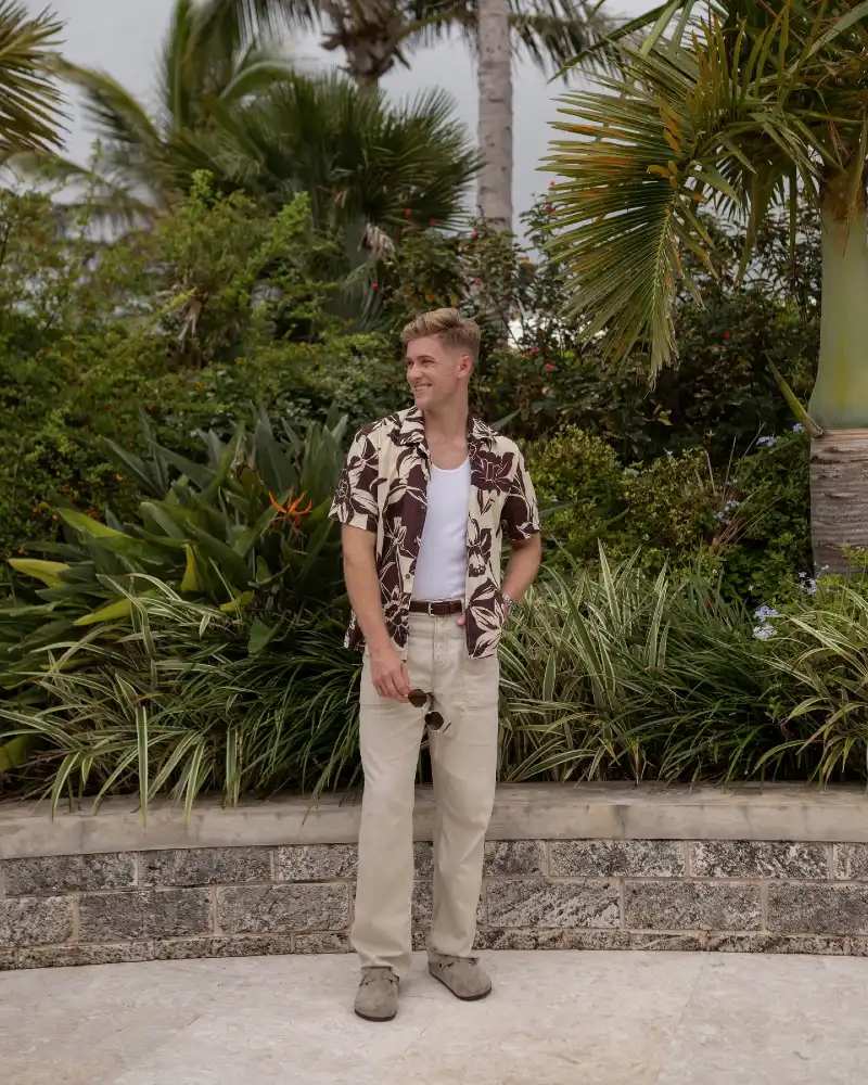 Brown Floral Short Sleeve Shirt with White Tank and Beige Trousers
