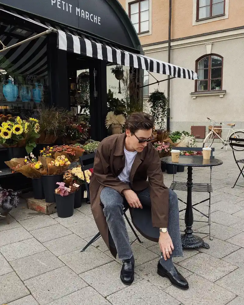 Brown Overcoat with Raw Hem Grey Jeans and Black Loafers