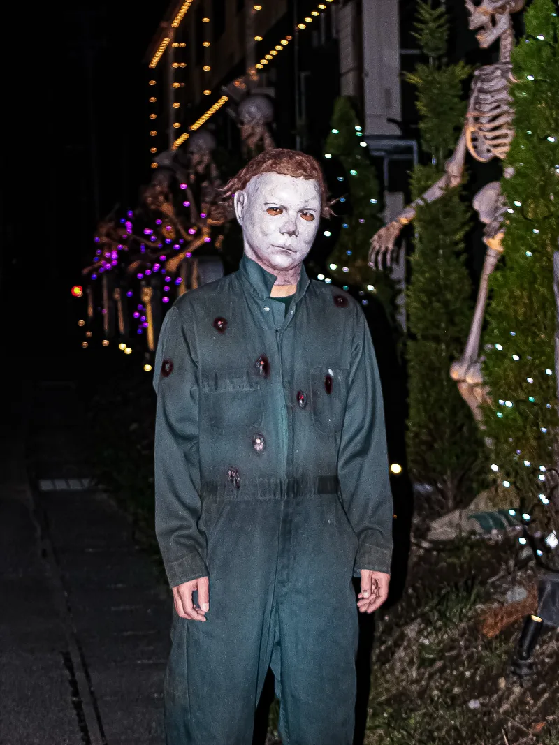 Bullet-Riddled Dark Green Coveralls with Pale Mask