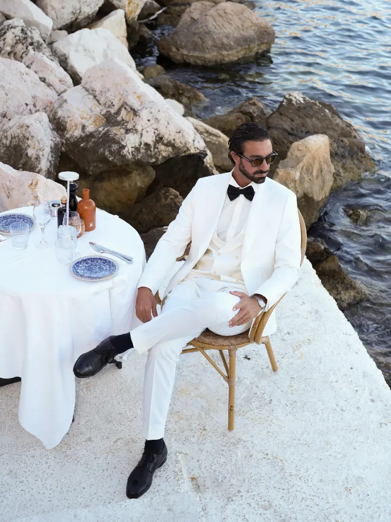 Crisp White Three-Piece Suit with Black Bow Tie