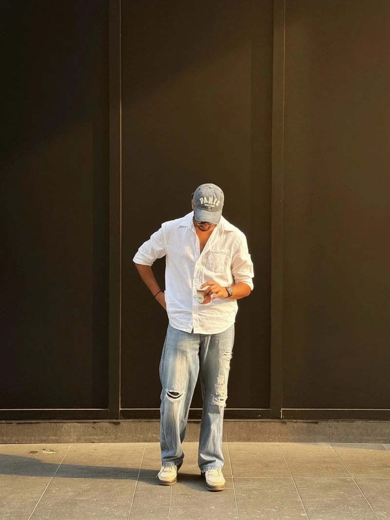 Distressed Light Wash Jeans with White Linen Shirt and Baseball Cap