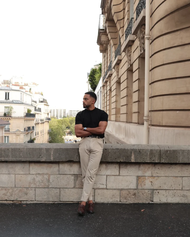 Fitted Black T-Shirt with Tailored Beige Trousers and Dark Loafers