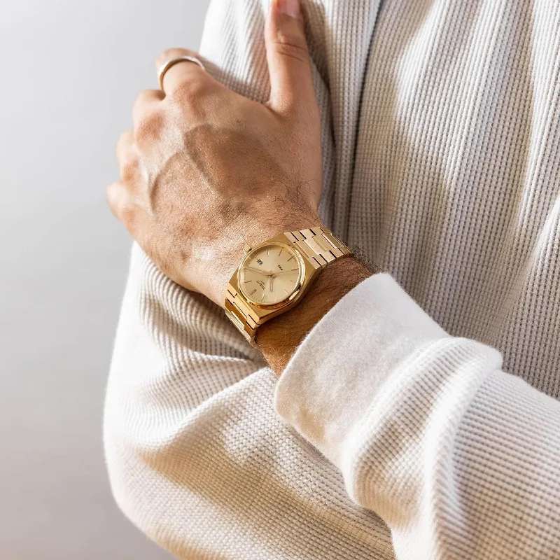 Gold Integrated Bracelet Watch with Off-White Waffle-Knit Shirt