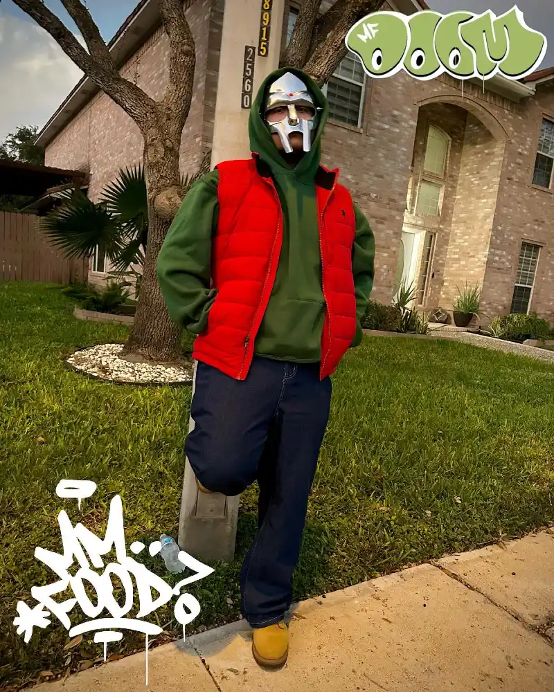 Green Pullover Hoodie with Red Puffer Vest and Metal Mask