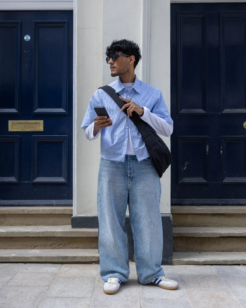 Light Wash Baggy Jeans with Layered Cropped Striped Shirt and Retro Sneakers