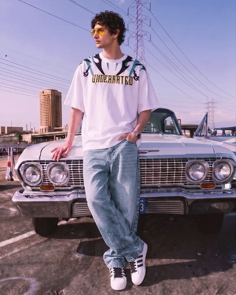 Light Wash Baggy Jeans with Oversized Graphic Tee and Striped Sneakers