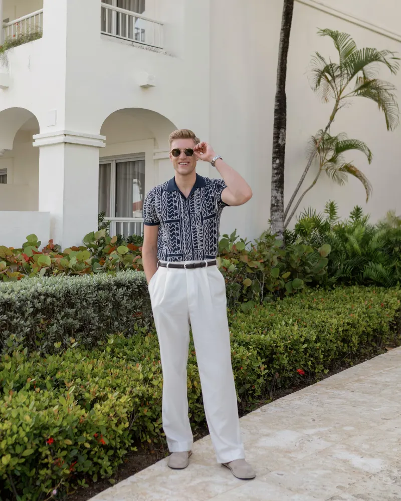 Navy Geometric Knit Polo with White Pleated Trousers