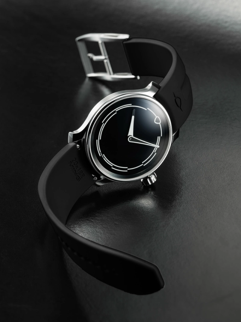 Polished Steel Watch with Concentric Ring Dial and Black Rubber Strap