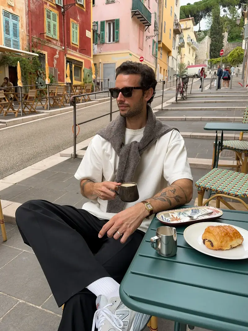Relaxed Black Trousers with White Tee and Shoulder-Tied Sweater