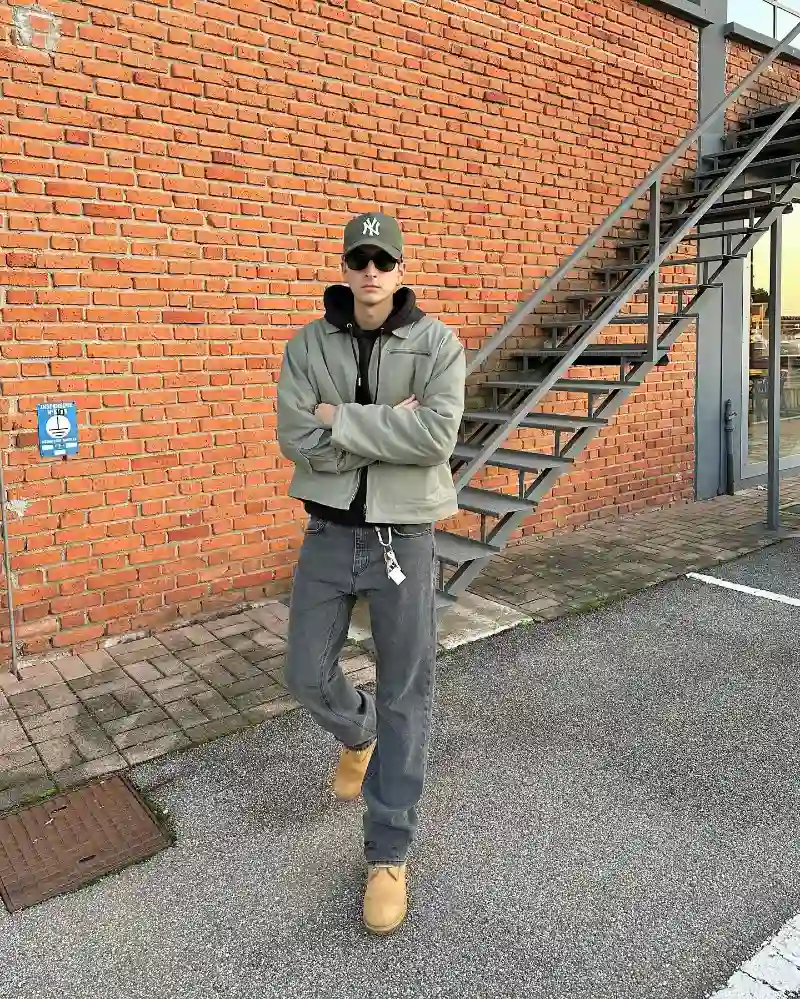 Sage Green Cropped Jacket over Black Hoodie with Faded Grey Jeans