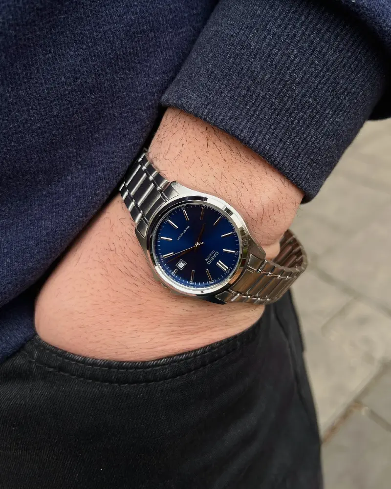 Steel Watch with Vibrant Blue Dial and Navy Ribbed Sweatshirt