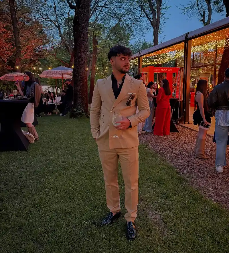 Tan Double-Breasted Suit with Unbuttoned Black Shirt and Patent Loafers