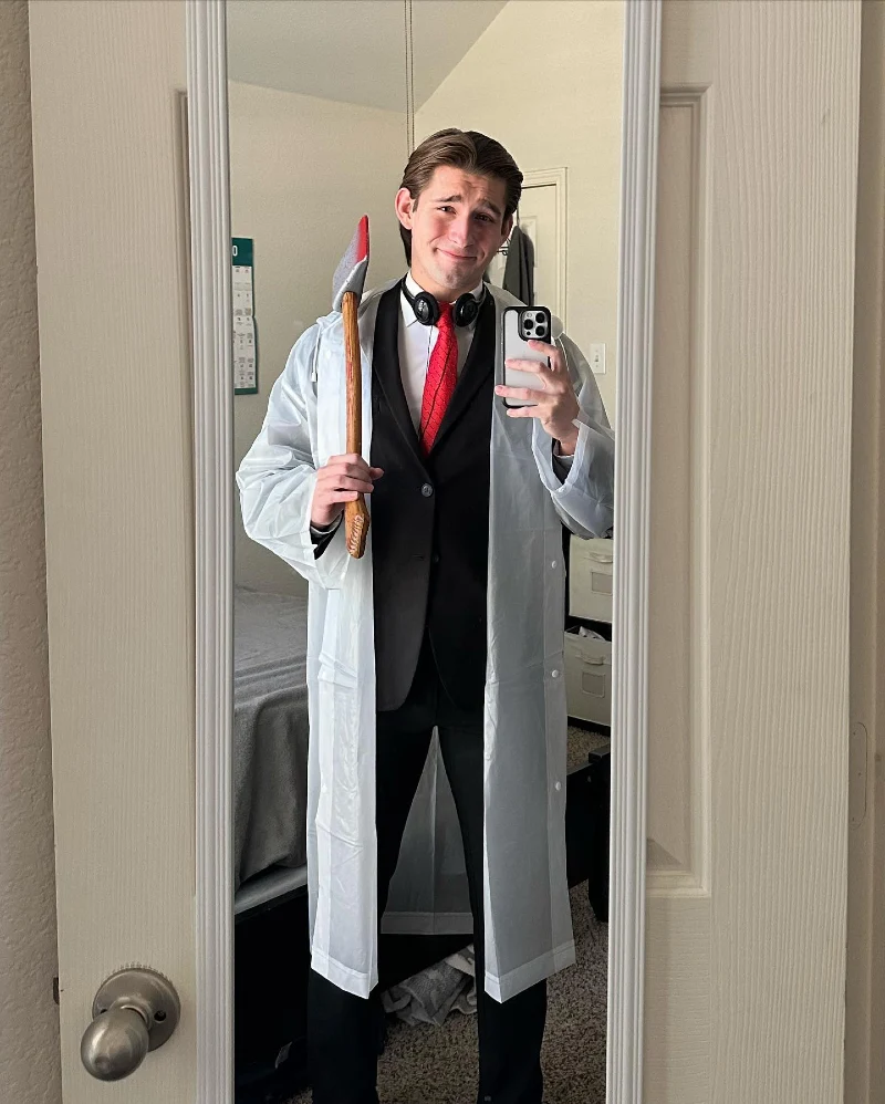 Translucent Raincoat over Black Suit with Red Micro-Pattern Tie