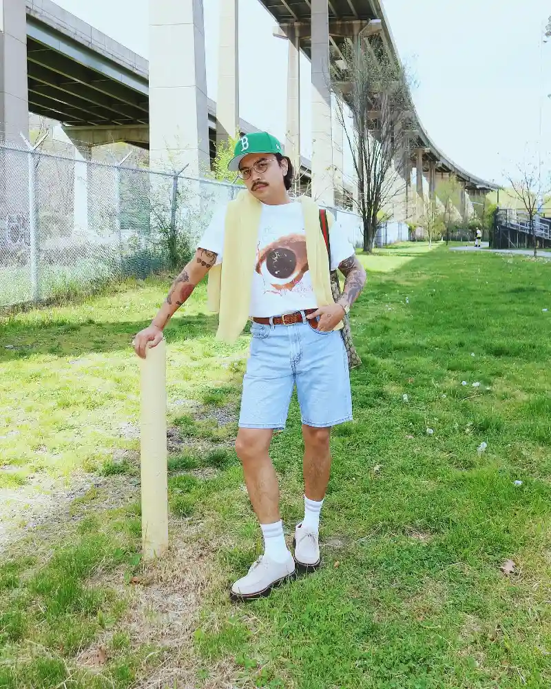 Tucked White Graphic Tee with Light Wash Denim Shorts