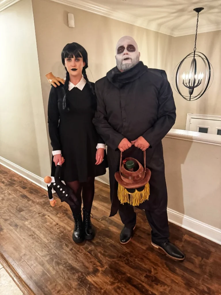 Uncle Fester and Wednesday Addams with Black High-Collar Coat and Collared Dress