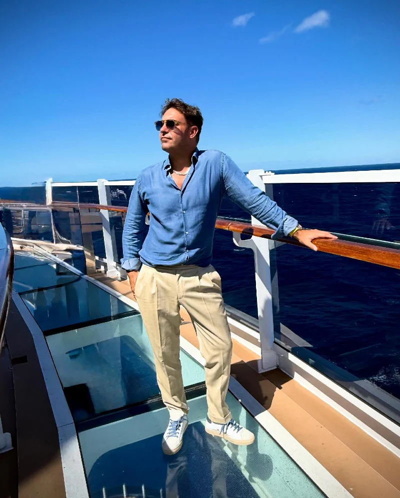 Washed Blue Linen Shirt with Beige Pleated Trousers and Sneakers