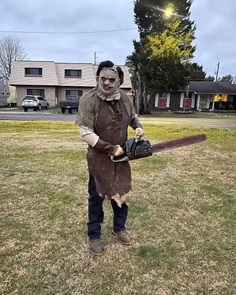 Weathered Leather Apron over Olive Short-Sleeve Shirt with Chainsaw