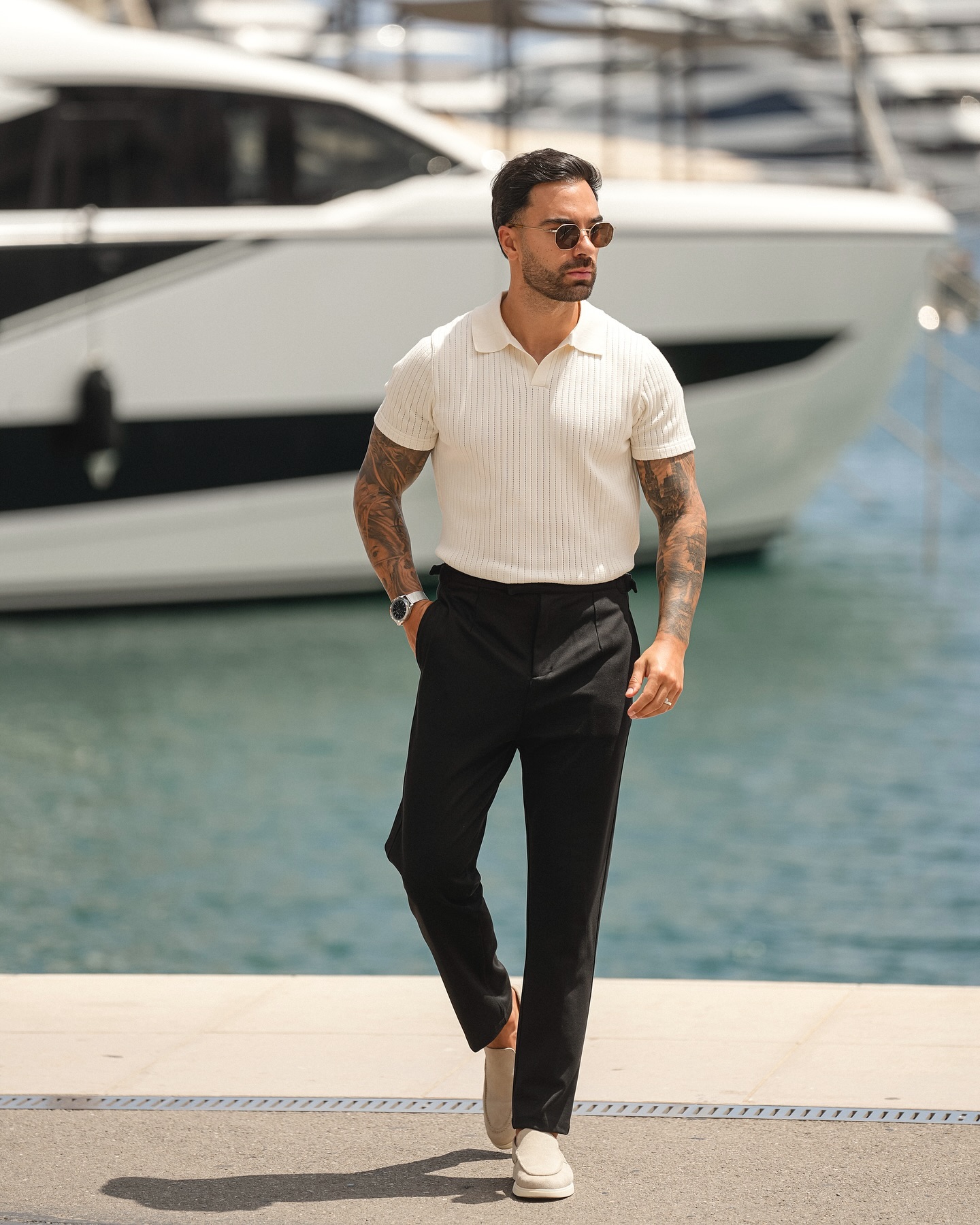White Knit Polo Tucked into Black Trousers with Beige Loafers